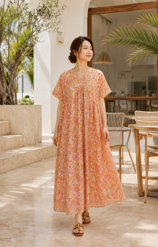 Model wearing the UNIQKY orange block-print cotton maxi dress with ribbon back, full length